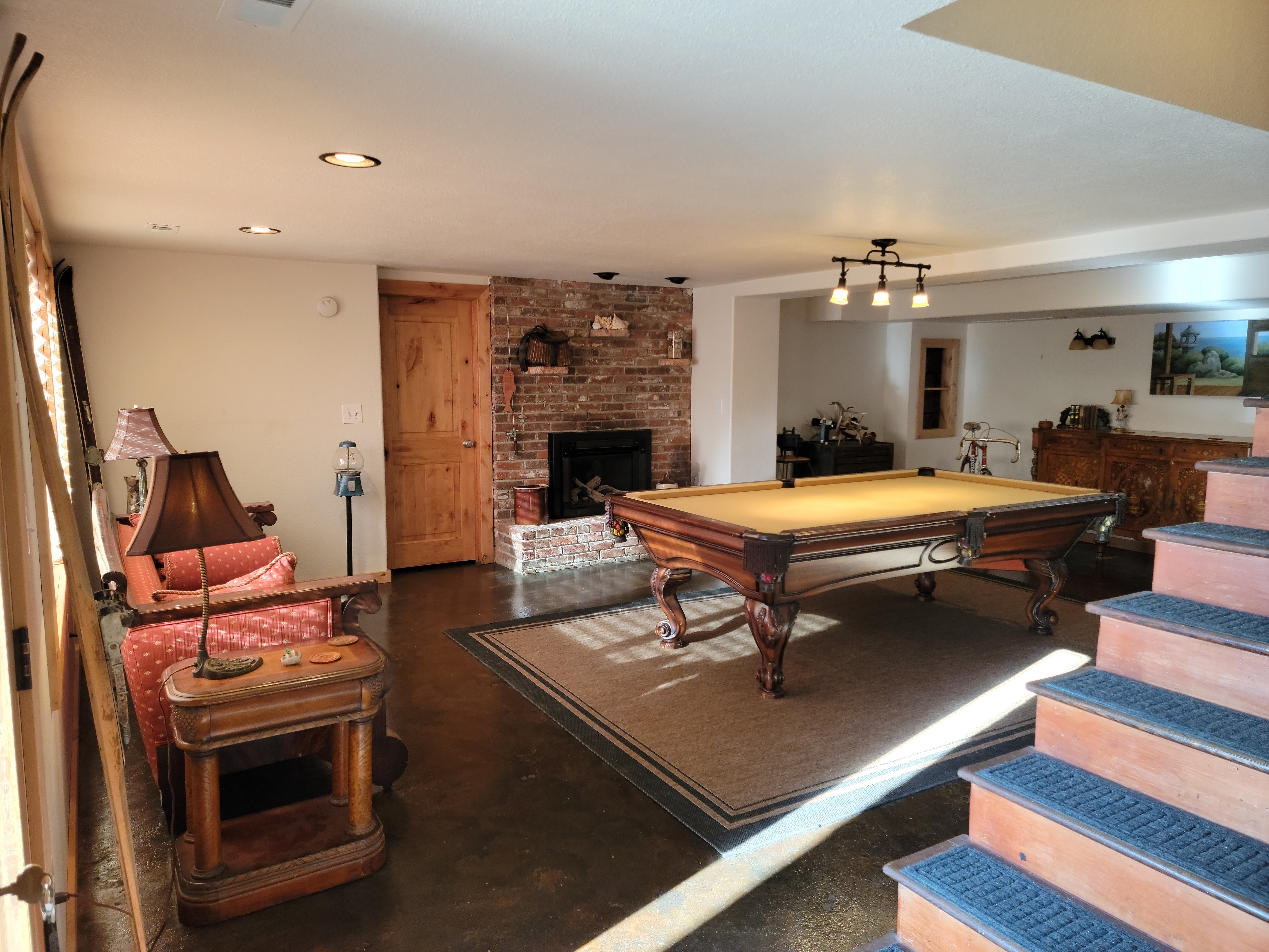 Family room with comfortable seating, layered furnishings and personal objects arranged for everyday living.