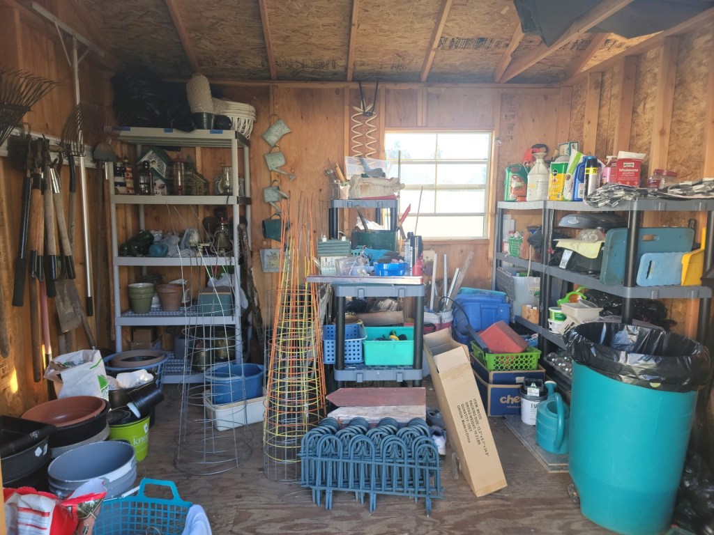 416305949_122136837260070980_9084111237844308841_n Garden shed before editing, with tools, supplies and outdoor equipment filling the available storage space.